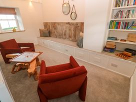A snug with armchairs and a bookshelf at Silvermine House Charlestown
