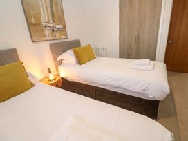 A bedroom with two single beds and a bedside table at Silvermine House in Charlestown