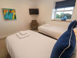 A bedroom with two beds and a chair at Silvermine House, Charlestown