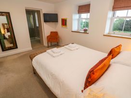 A bedroom with a bed and a chair at Silvermine House in Charlestown