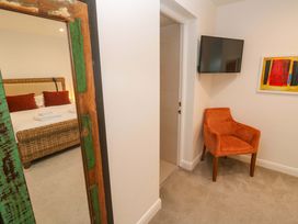 A bedroom with a bed and chair at Silvermine House in Charlestown