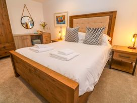 A bedroom with a bed, nightstand, and wardrobe at Silvermine House Charlestown