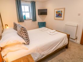 A bedroom with a bed, television, and window at Silvermine House Charlestown