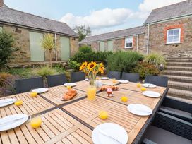An outdoor dining area with a table set for breakfast at Silvermine House in Charlestown