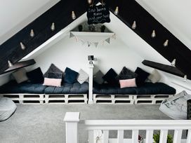 A snug with seating area and hanging lights at Trearddur View in Treaddur Bay