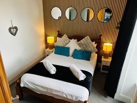 A bedroom with a bed and lamps at Trearddur View in Treaddur Bay