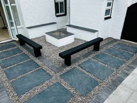 An outdoor space with paving stones and a fire pit at Trearddur View in Treaddur Bay