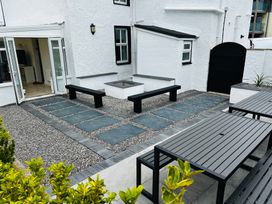 A garden with benches and a fire pit at Trearddur View in Treaddur Bay