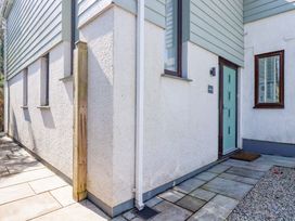 An exterior view of a house with a door and pathway at Little Pippin in Carlyon Bay near St Austell