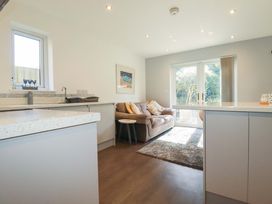 A kitchen with a sofa and coffee table at Little Pippin Carlyon Bay near St Austell