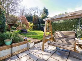 A garden with a swing and plants at Little Pippin in Carlyon Bay near St Austell