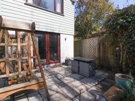 A garden with a swing and paving stones at Little Pippin in Carlyon Bay near St Austell