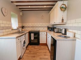 A kitchen with appliances and cabinetry at Stable Cottage in Staintondale near Burniston