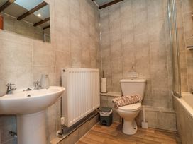 A bathroom with sink, toilet, and bathtub at Stable Cottage Staintondale near Burniston