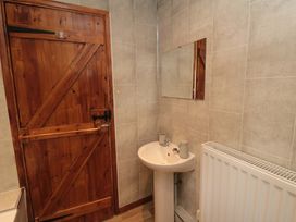 A bathroom with a sink and mirror at Stable Cottage in Staintondale near Burniston