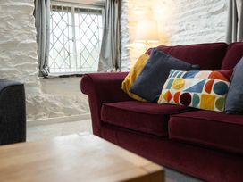 A living room with a sofa and cushions at The Coach House in Llangollen