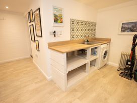 A kitchen with a sink and washing machine at The Coach House Llangollen