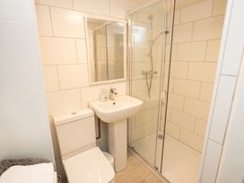 A bathroom with a shower, sink and toilet at The Coach House in Llangollen