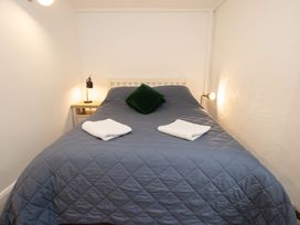 A bedroom with a bed and bedside table at The Coach House Llangollen