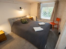 A bedroom with a bed and window at The Coach House in Llangollen