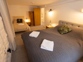 A bedroom with a double bed and a single bed at The Coach House in Llangollen