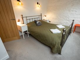 A bedroom with a bed and nightstands at The Coach House Llangollen