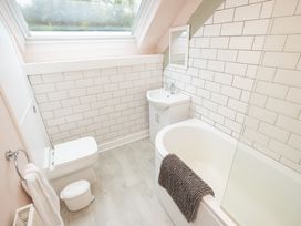 A bathroom with a sink and bathtub at The Coach House in Llangollen