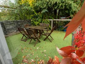 An outdoor seating area with a table and chairs at The Coach House in Llangollen