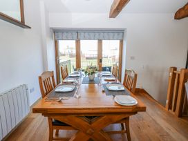 A dining room with table set for meals at Apple Tree Cottage Bleatarn near Kirkby Stephen