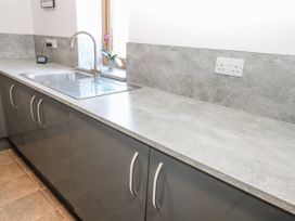 A kitchen with a sink and cabinets at Apple Tree Cottage near Kirkby Stephen