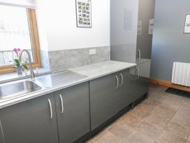 A kitchen with a sink and cabinets at Apple Tree Cottage Bleatarn near Kirkby Stephen