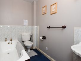 A bathroom with a bathtub and toilet at Blueberry Cottage in Akeld near Wooler