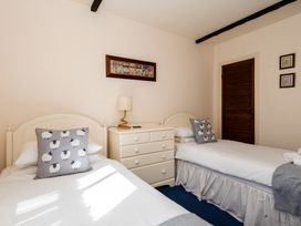 A bedroom with two single beds and a dresser at Blueberry Cottage in Akeld near Wooler