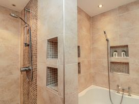 A bathroom with a shower and bath at Apartment 6 in Whitby