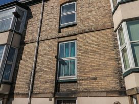 A building facade with a hotel sign and multiple windows at Apartment 6 in Whitby