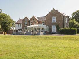A house with a conservatory and garden at Maes Elwy in St Asaph