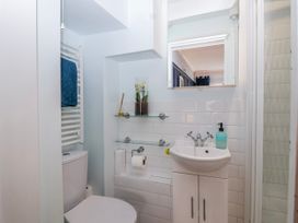 A bathroom with a sink and toilet at Lily Cottage Looe