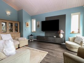 A living room with a sofa and television at Links View in Fritton