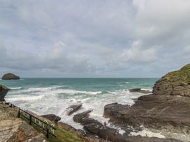 An ocean view with waves and rock formations at Smugglers Cottage in Trebarwith Strand near Tintagel