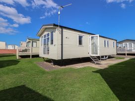 A static caravan with steps and grass at K2 Static Caravan 