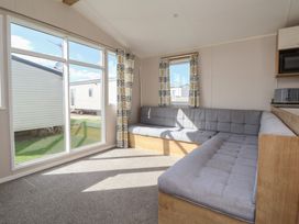 A living room with a sofa and windows at K2 Static Caravan