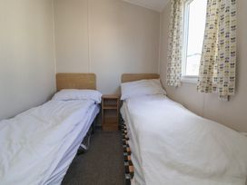 A bedroom with two single beds at K2 Static Caravan