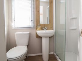 A bathroom with a sink, toilet, and shower at K2 Static Caravan 