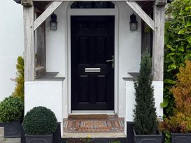 A front entrance with a black door and planters at Penlaurel Launceston