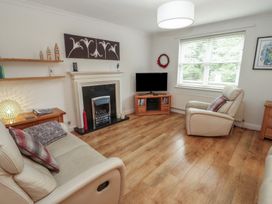A living room with furniture and a television at Riverside Cottage in Cockermouth