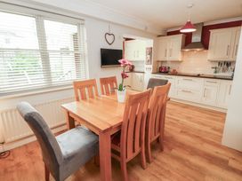 A dining area with a table and chairs at Riverside Cottage in Cockermouth