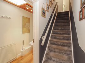 A staircase and toilet visible in the hallway at Riverside Cottage Cockermouth
