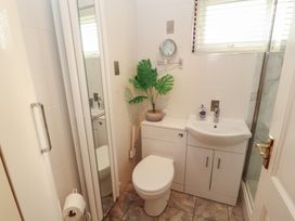 A bathroom with a toilet and sink at Riverside Cottage in Cockermouth