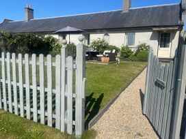 A garden with a fence and patio furniture at Mappowder Cottage Buckland Newton near Dorchester