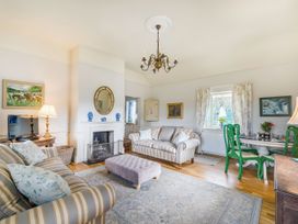 A living room with seating and decor at Mappowder Cottage Buckland Newton near Dorchester
